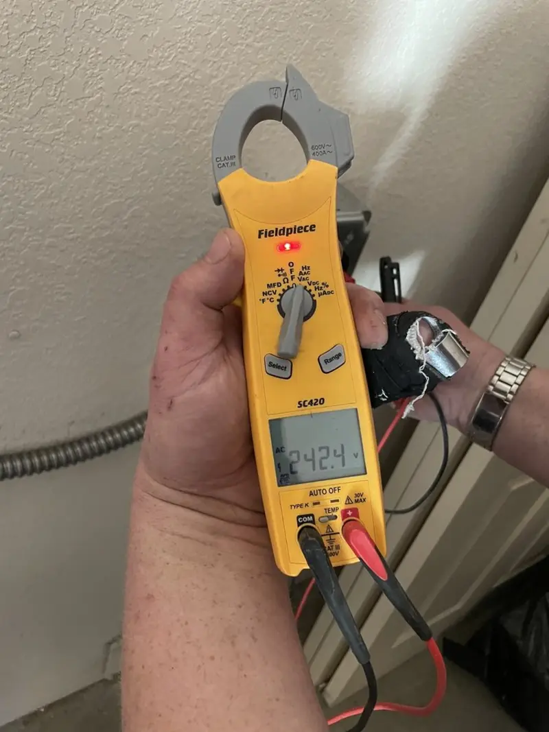 Voltage testing with clamp meter during Ceiling Fan Installation in Saranac